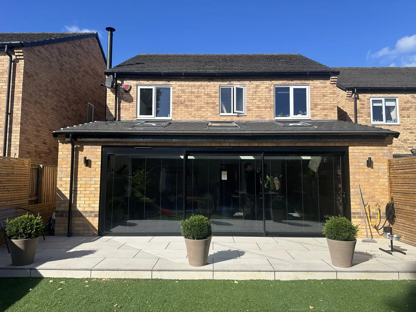 A finished installation of dark aluminium glazing on a domestic property.