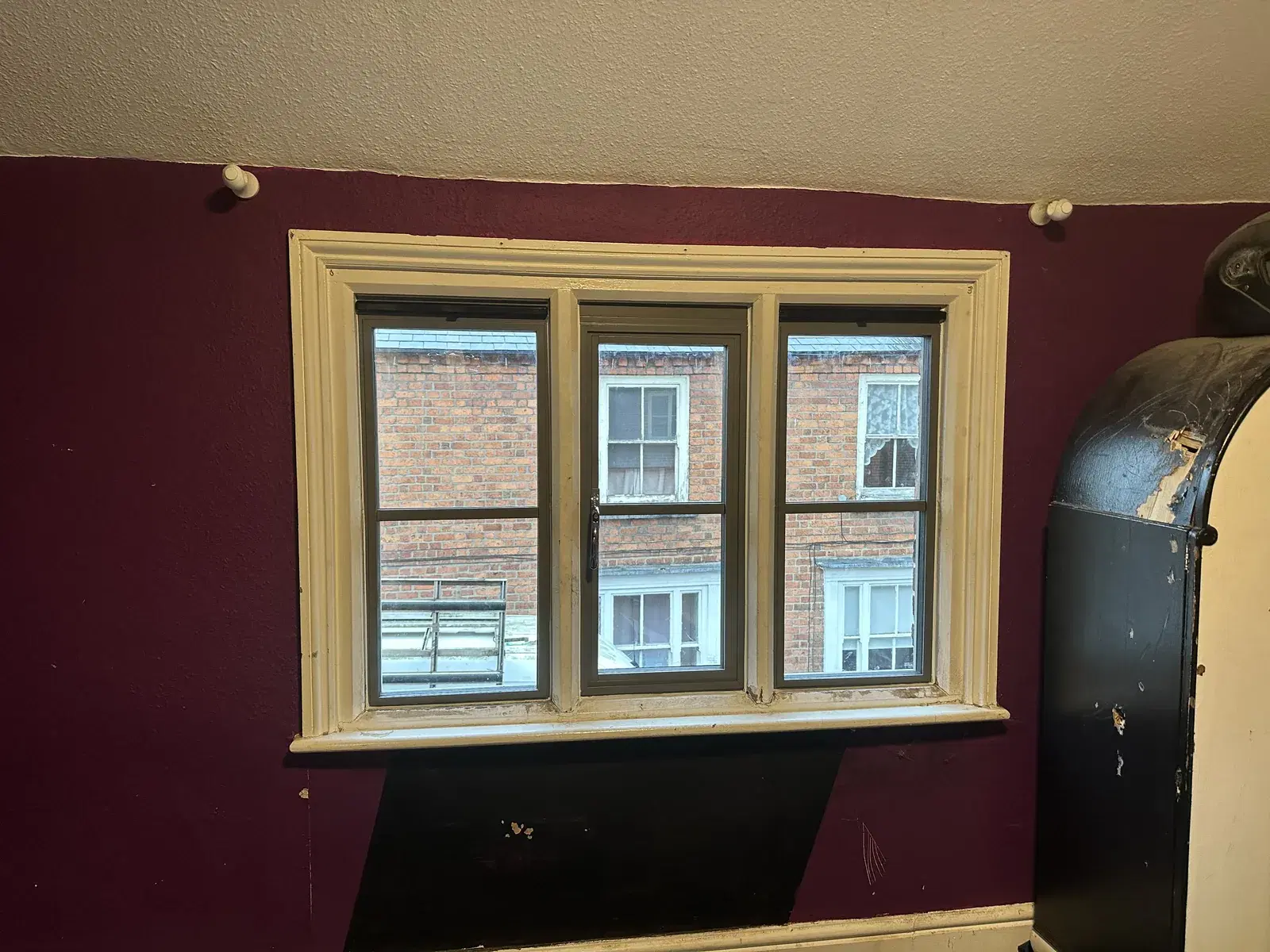 Dark heritage casements set into a period stone building.