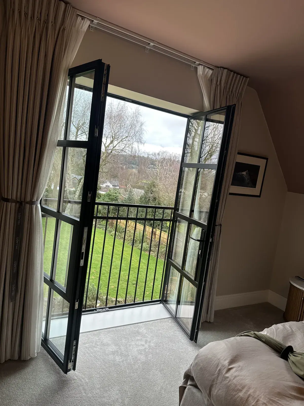 A tall heritage window with traditional glazing bars in an older brick wall.