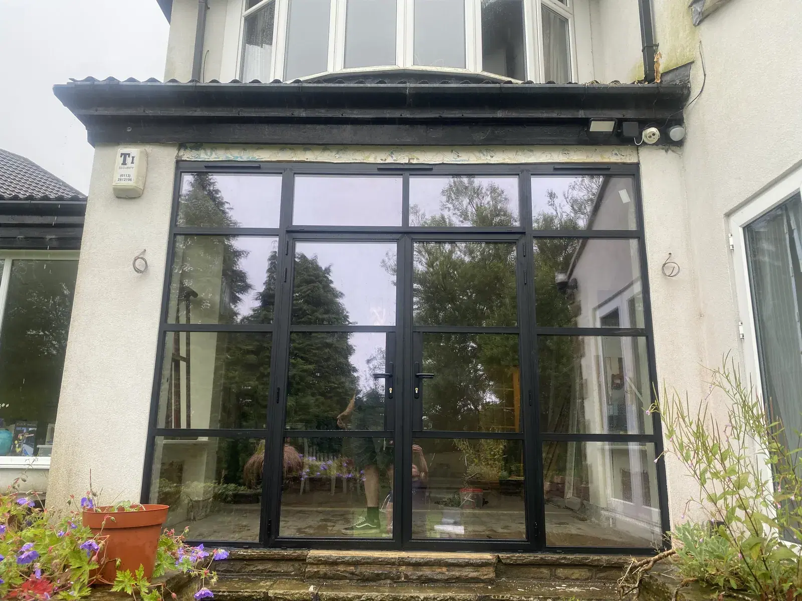 Black heritage windows across the elevation of an older property.