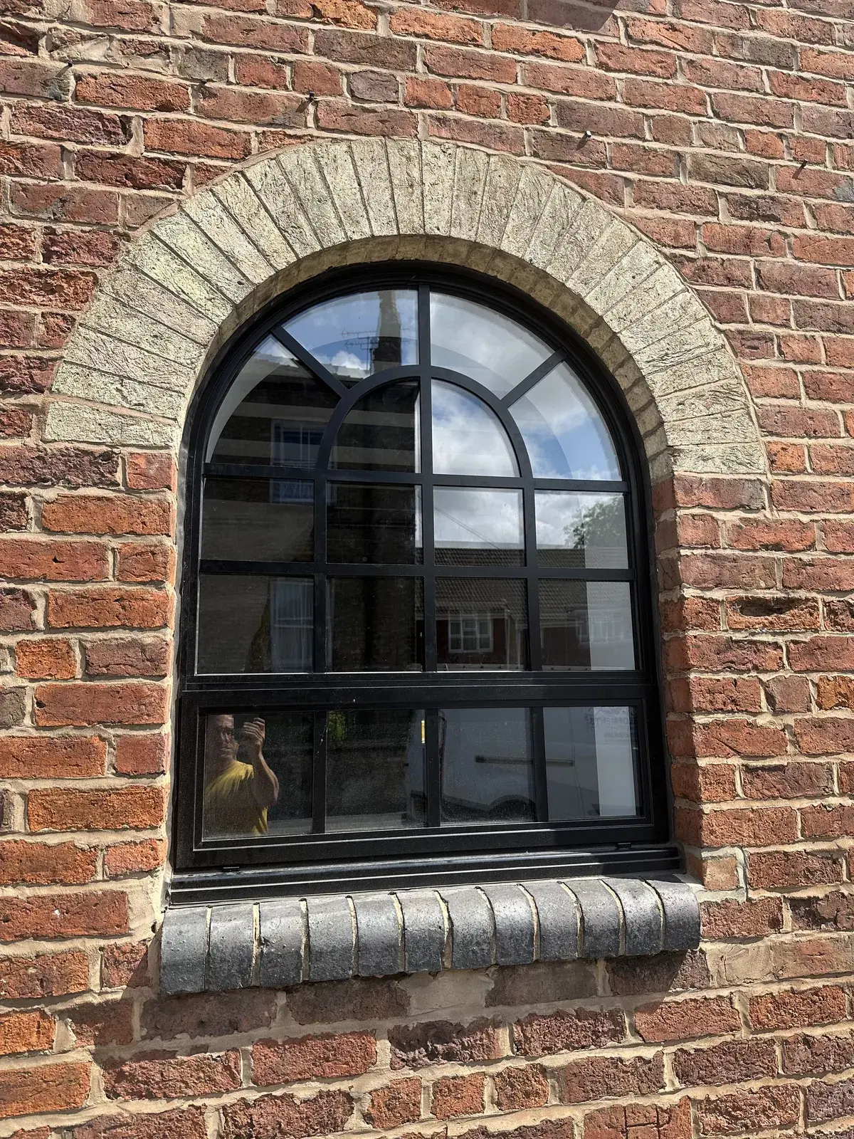 A heritage window with period glazing bars, viewed from the exterior.